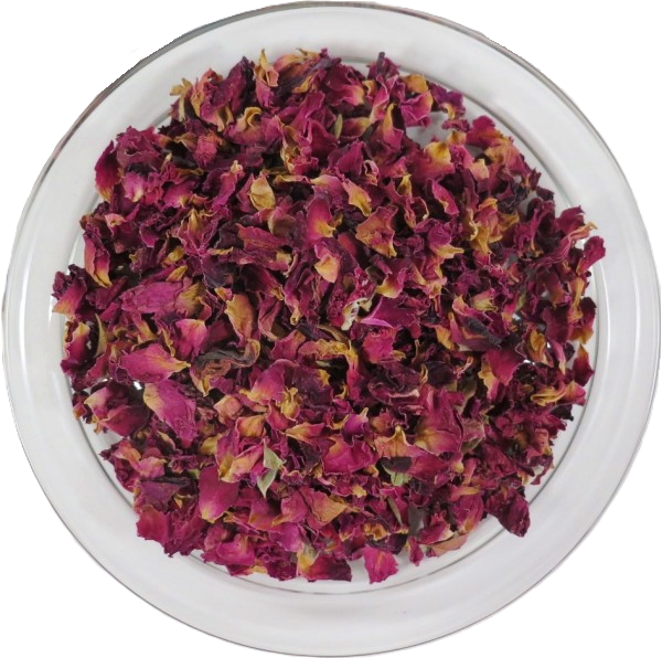 Draufsicht auf getrocknete, geschnittene Rosenblütenblätter in einer klaren Glasschale. Die fragmentierten Blütenblätter zeigen ein intensives Farbspiel aus tiefem Magenta und Rosa mit gekräuselter Textur.