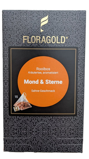 Eine dunkelgraue FLORAGOLD-Verpackung mit goldenem Logo und Ornamentmuster. Ein schwarzes Quadrat in der Mitte umfasst einen orange-braunen Kreis mit weißem Text: "Rooibos Kräutertee, aromatisiert", "Mond & Sterne", "Sahne-Geschmack". Unten links steht "1